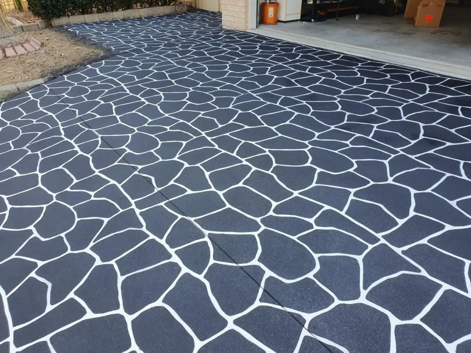 Dark decorative concrete driveway with patterned finish