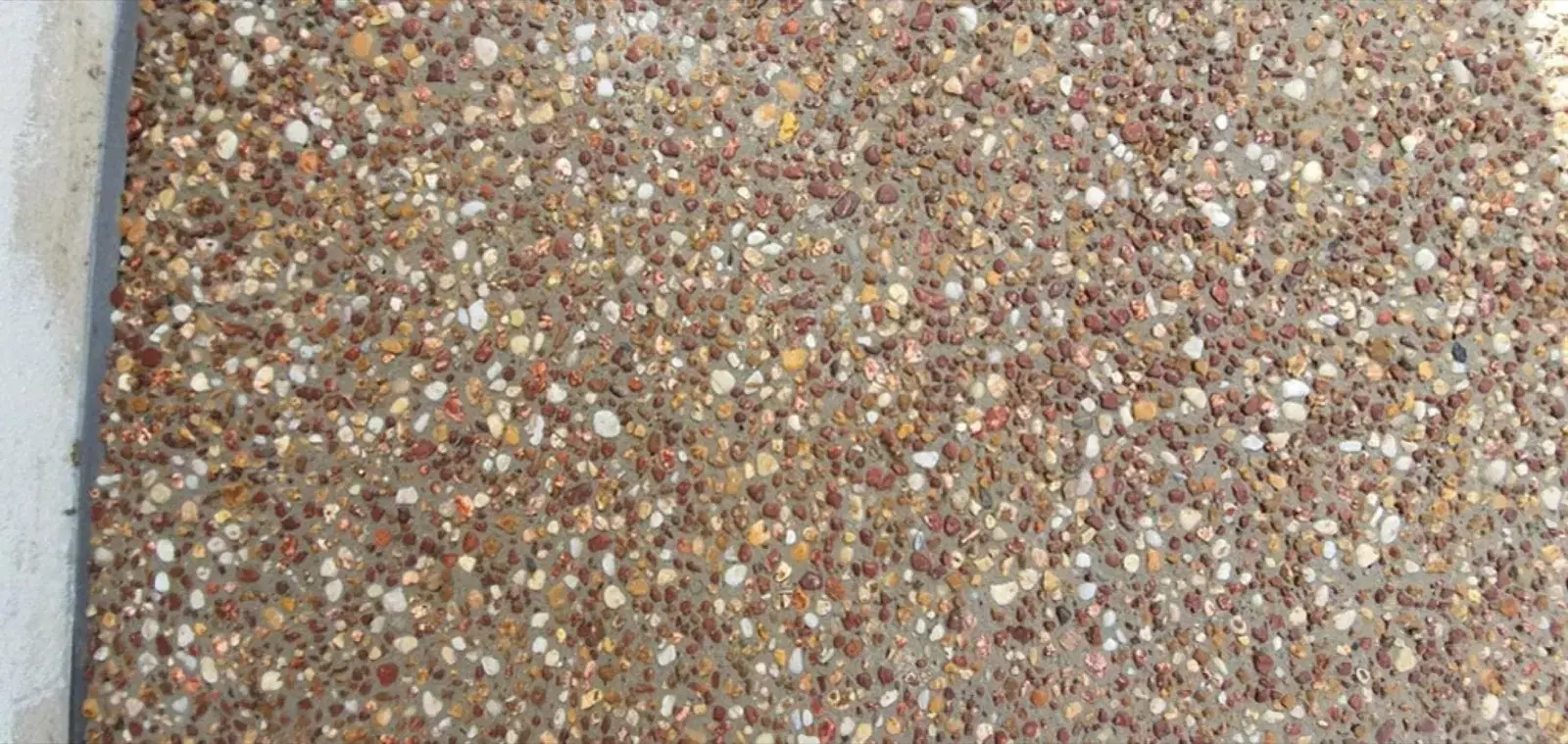Close-up of warm-toned exposed aggregate concrete finish