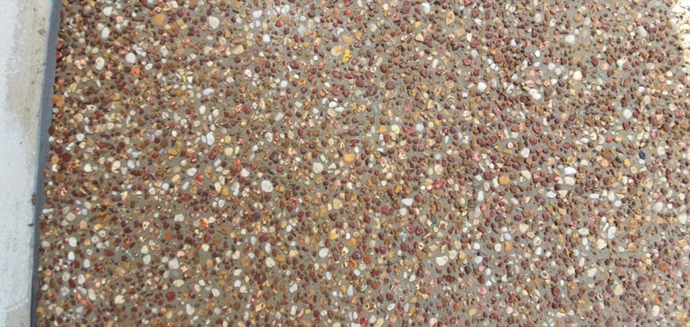 Close view of a warm-toned exposed aggregate concrete finish