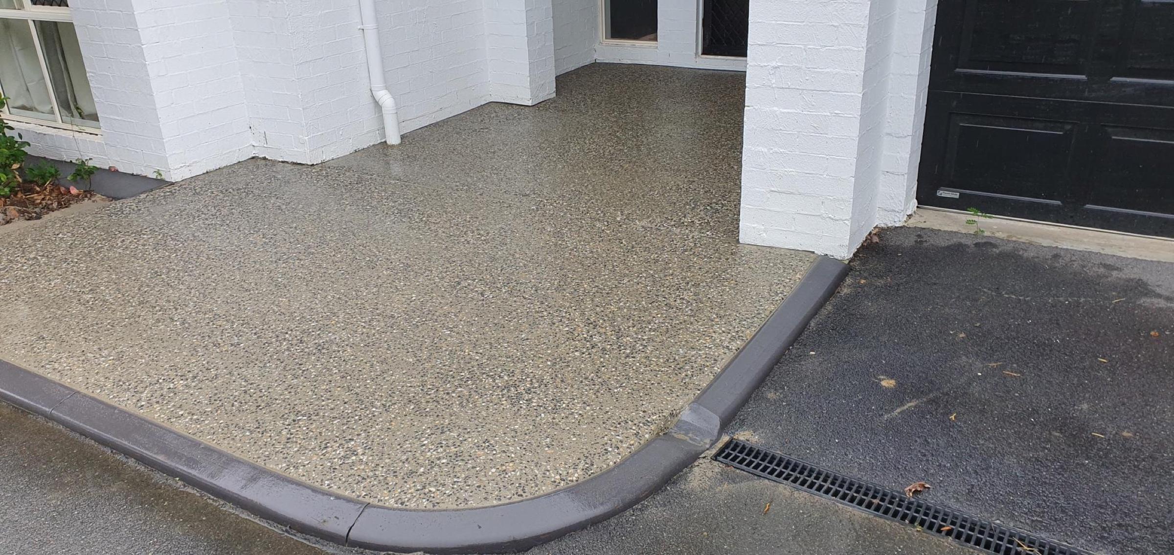 Exposed aggregate entry and outdoor area with curved edging